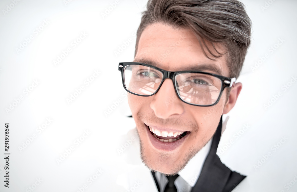 confident businessman breaking through a white paper wall