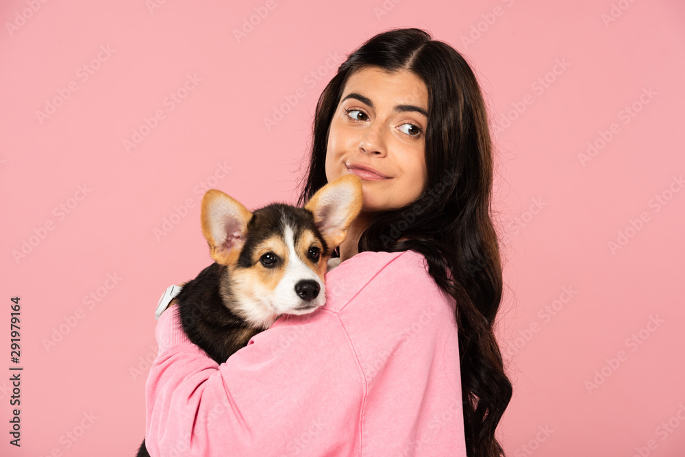 smiling woman holding Welsh Corgi puppy, isolated on pink smiling woman holding Welsh Corgi puppy, isolated on pink