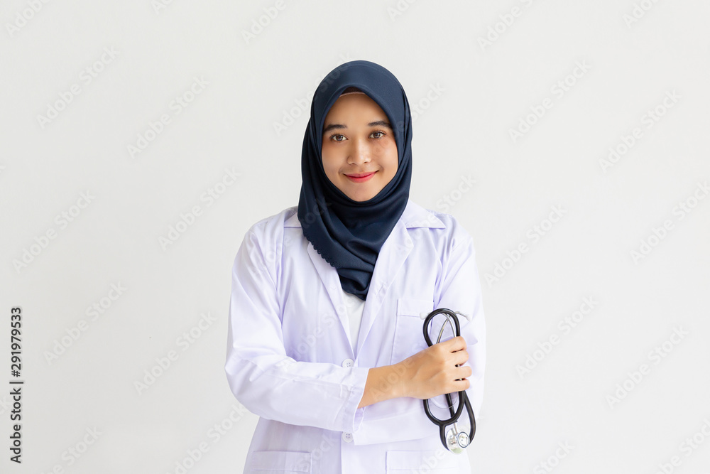 Young Arab Muslim intern doctor women smile on isolate white background concept for Islam people working in medical hospital health care, Modern Nurse wearing hijab in medico clinic business service. Young Arab Muslim intern doctor women smile on isolate white background concept for Islam people working in medical hospital health care, Modern Nurse wearing hijab in medico clinic business service.