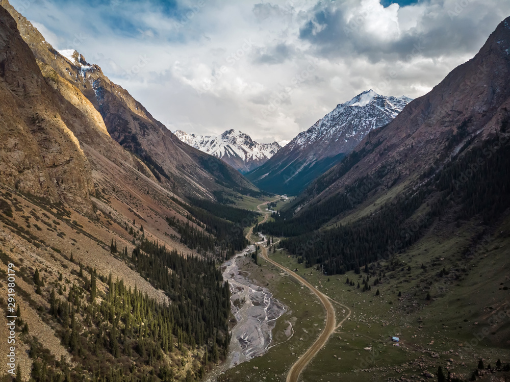 Valley with wild river and mountains in the background Valley with wild river and mountains in the background