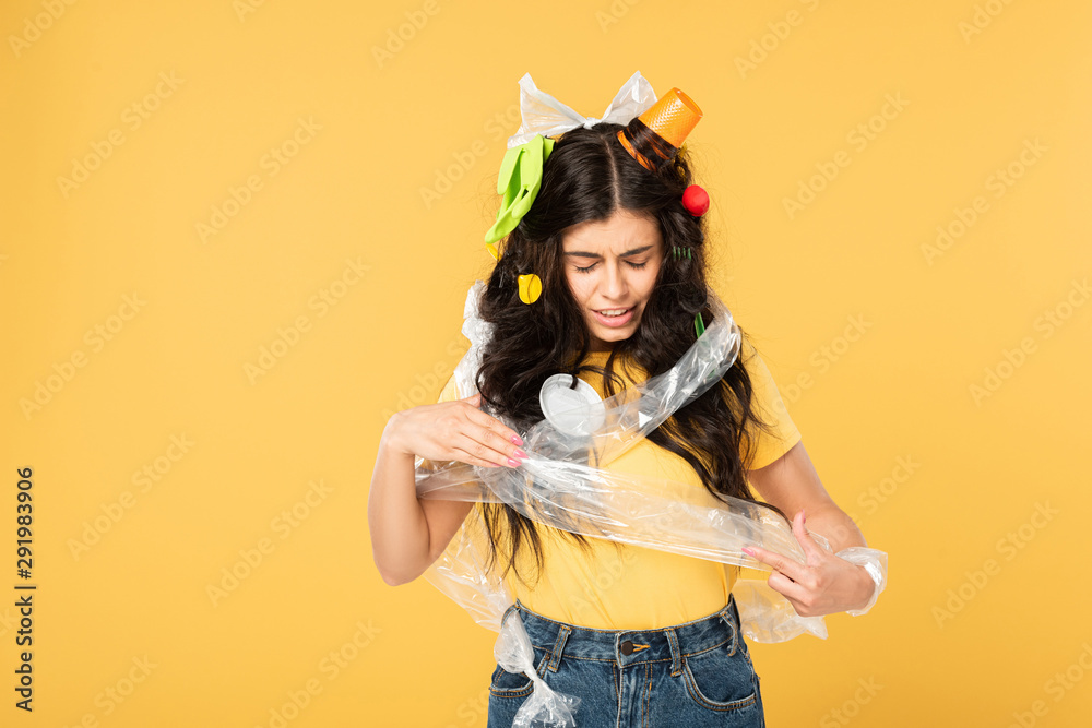 confused young woman with rubbish in hair isolated on yellow confused young woman with rubbish in hair isolated on yellow