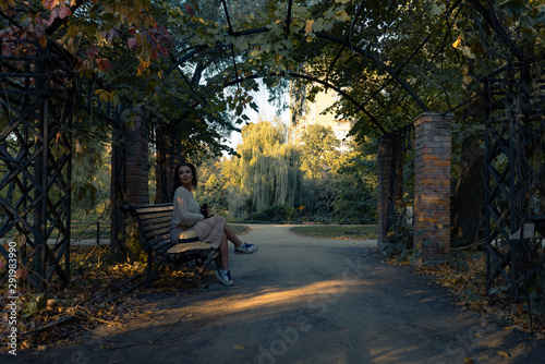 Wallpaper Mural Woman in romantic attire relaxing outdoor in autumn park and enjoying good weather view on pond and sunset. Torontodigital.ca