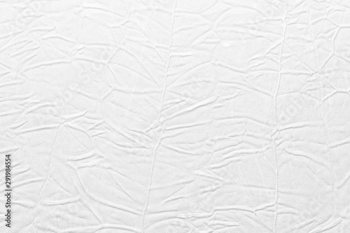 White crumpled leather texture. fabric with folds imitation under genuine leather. background. wallpaper