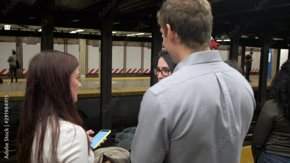 Young people having fun at a subway station waiting for the train to arrive Young people having fun at a subway station waiting for the train to arrive