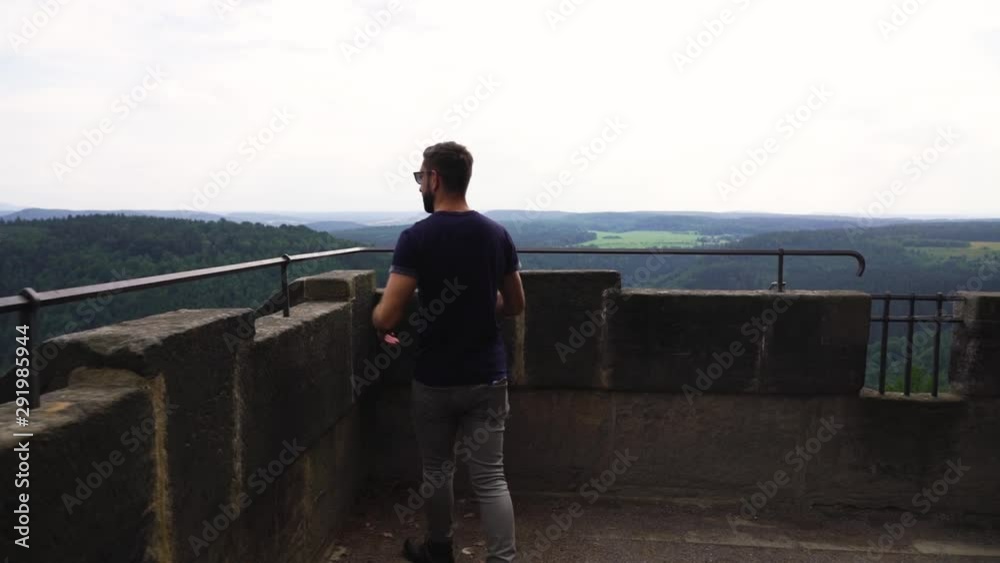 man walking on a viewing platform at konigstein fortress, germany man walking on a viewing platform at konigstein fortress, germany