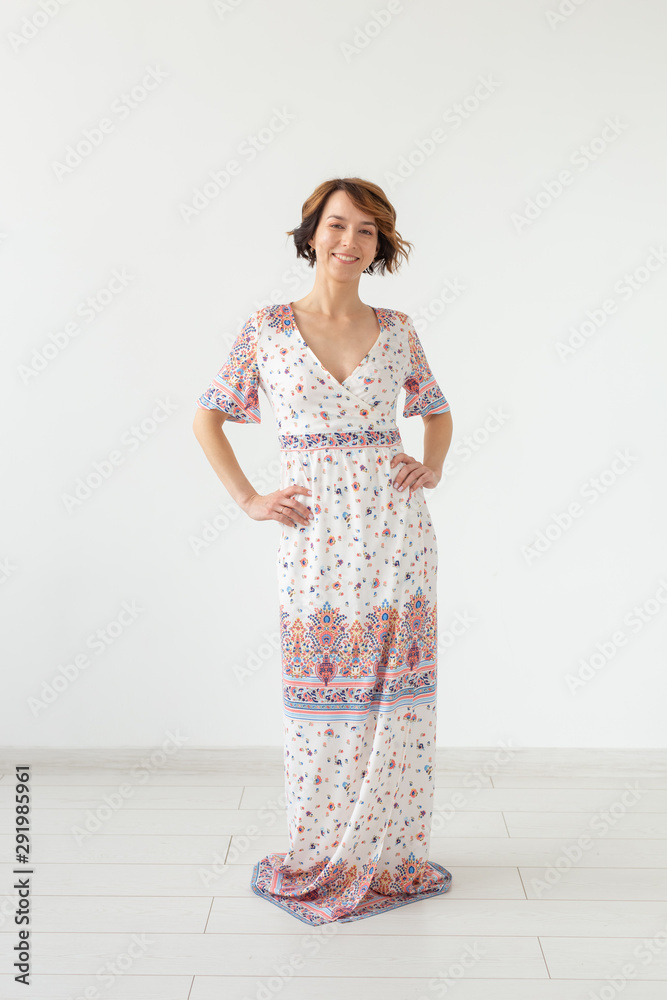 people, fashion and style concept - young woman posing in clothes in studio on white background people, fashion and style concept - young woman posing in clothes in studio on white background