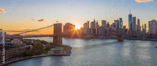 New York City skyline buildings Brooklyn Bridge evening sunset