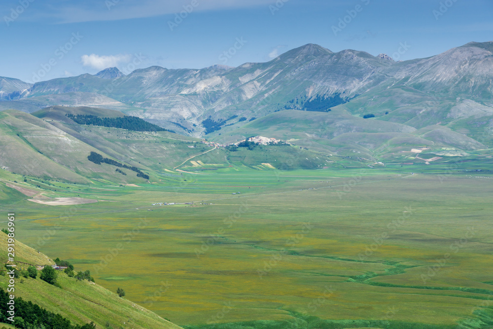 View of the Castelluccio di Norcia valley a village in Umbria, in the Apennine Mountains of central Italy. View of the Castelluccio di Norcia valley a village in Umbria, in the Apennine Mountains of central Italy.