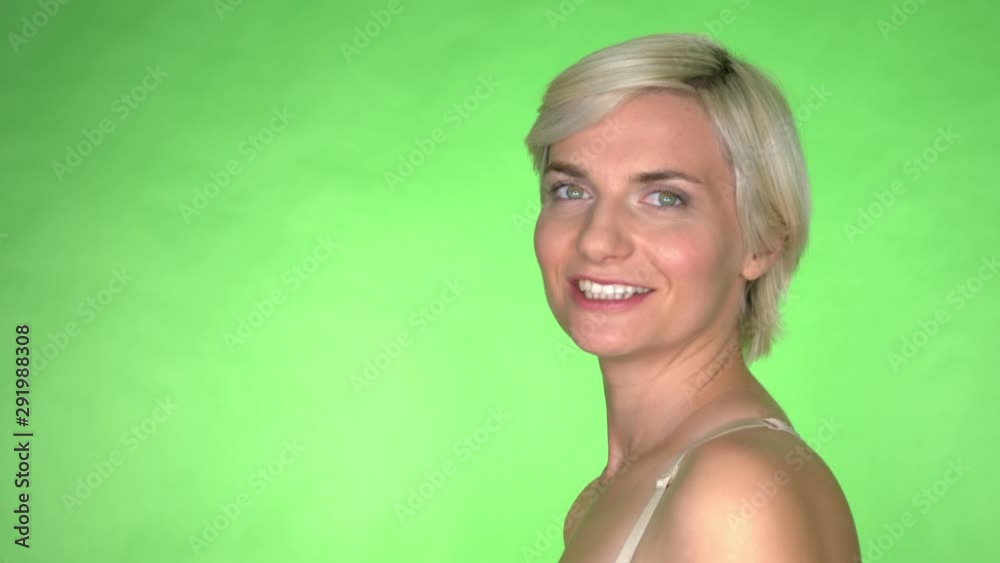 Blonde woman looking at camera and smiles. Close up isolated on green background Blonde woman looking at camera and smiles. Close up isolated on green background