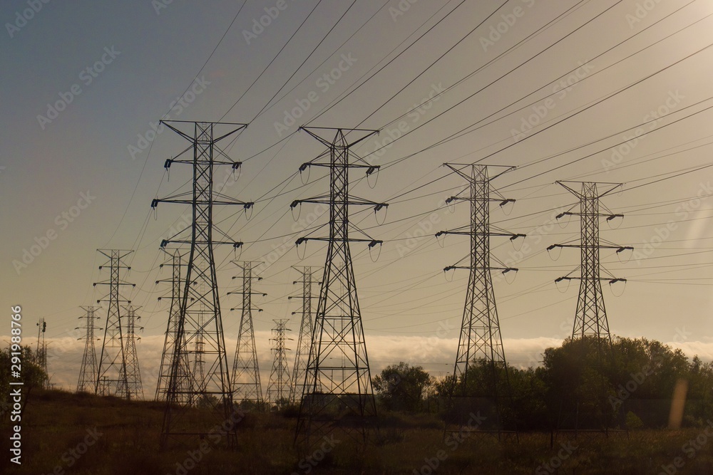 Fototapeta premium power lines and pylons at sunrise