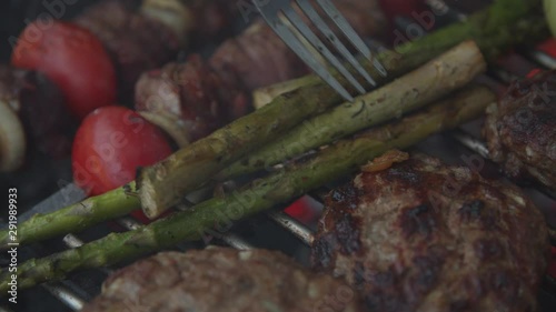 Outdoor grill with beef and vegatables in slow motion.  photo