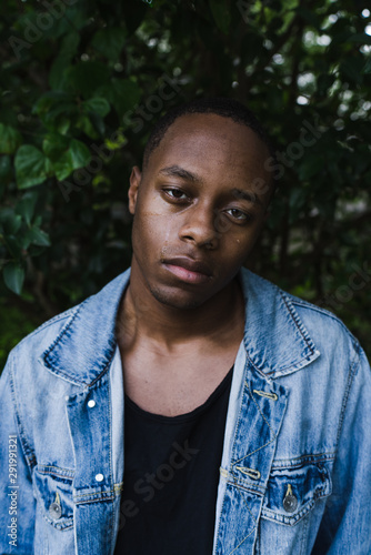 Young man crying and holding hand to face