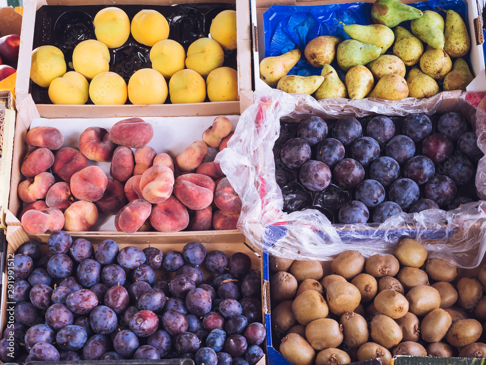 different fresh fruits in a grocery store different fresh fruits in a grocery store
