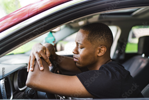 Young man crying while yelling and clenching fists