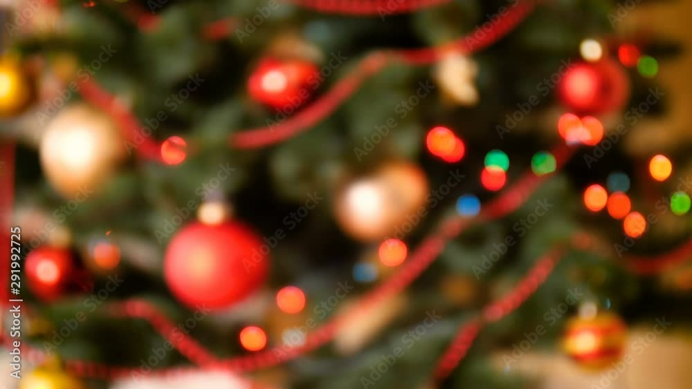 4k out of focus abstract video of colorful lights glowing and blinking on Christmas tree. Perfect shot for winter celebrations and holidays