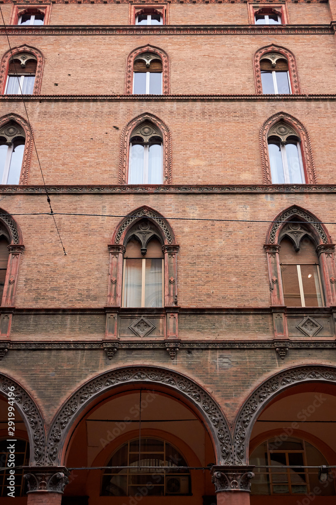 Facade of an old residental Italian brick building in Bologna