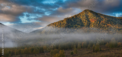 Panoramic picture of sunrise in Altai mountains nature reserve. The beginning of autumn, September