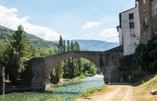 Romanesque bridge with a single arch, in Gerri de la Sal, on the Noguera Pallaresa river. Catalan Pyrenees. Catalonia, Spain.