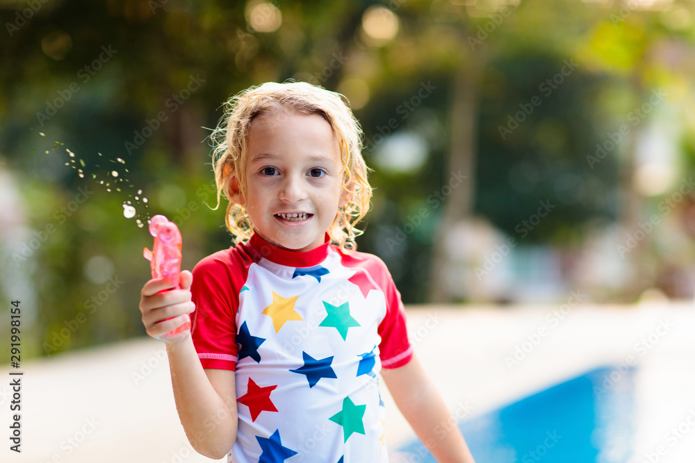Child in swimming pool. Summer vacation with kids. Child in swimming pool. Summer vacation with kids.