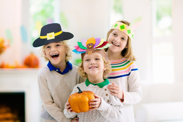 Child on Thanksgiving. Kid with autumn turkey hat.