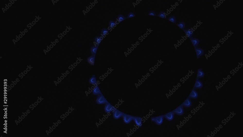 Slow motion - Blue flame gas burning from a Kitchen cooker stove hob, cooking ring top from above black isolated background Slow motion - Blue flame gas burning from a Kitchen cooker stove hob, cooking ring top from above black isolated background