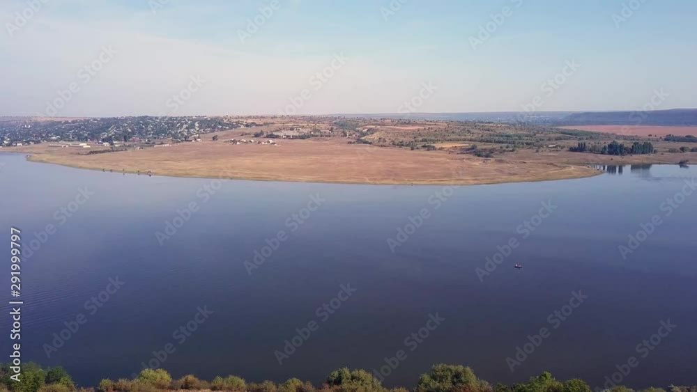Top view of Dnestr (Dniester) river in autumn. River surrounds yellow field and green forest. Moldova republic of. Top view of Dnestr (Dniester) river in autumn. River surrounds yellow field and green forest. Moldova republic of.