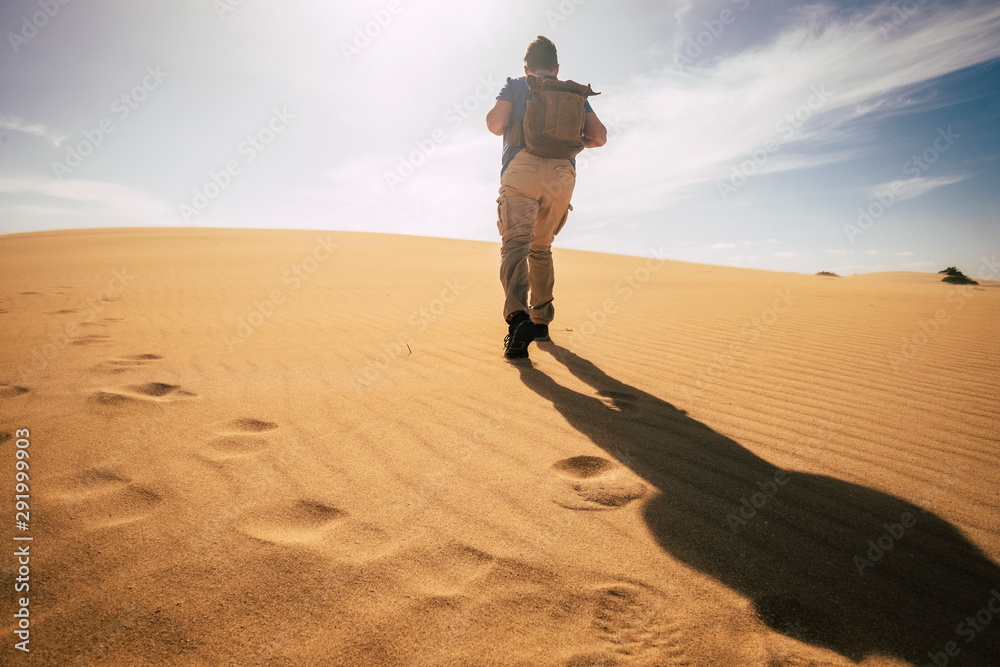Fotografie Climate change concept with man walkling with backpack in