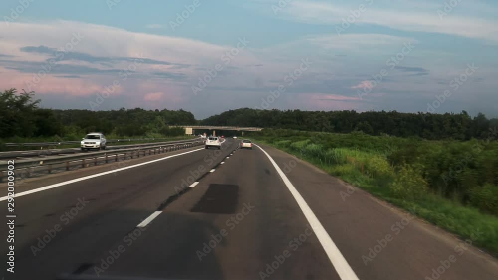 FPV: Driving along the highway. View of the road from the car window ...