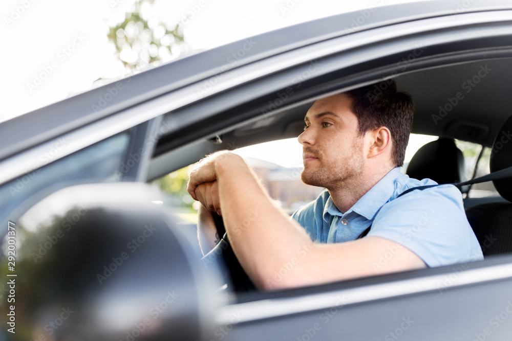 transport, vehicle and people concept - man or driver driving car in summer