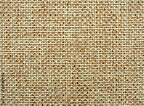 Close-up of hessian sackcloth woven vintage style material texture pattern background in beige color for used as backdrop or background