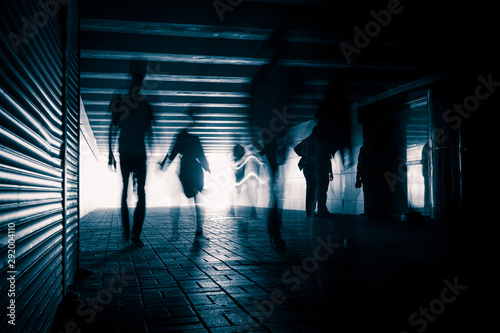 Silhouettes of people in the tunnel.