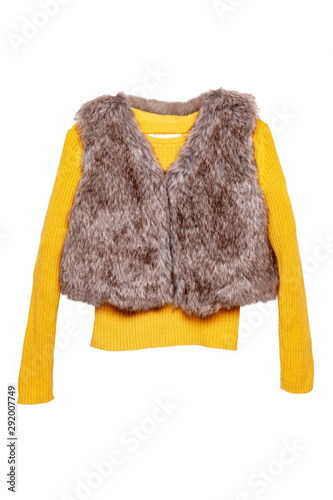 Autumn and winter children clothes. Yellow cozy warm long sleeve sweater or pullover with a trendy fur vest for child girl isolated on a white background.