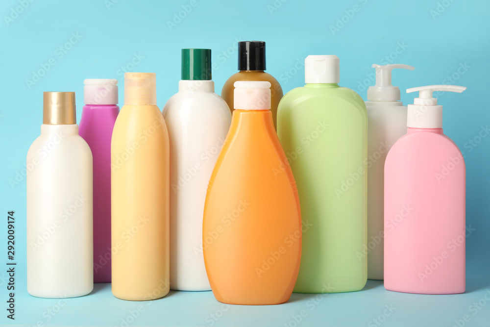 Bottles with different hair care cosmetics on light blue background Bottles with different hair care cosmetics on light blue background