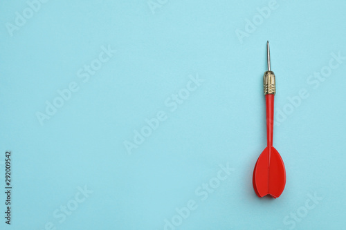 Red dart arrow on blue background, top view with space for text