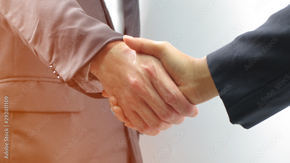 Close-up of business man shaking hand isolated on white background, business and meeting concept Close-up of business man shaking hand isolated on white background, business and meeting concept