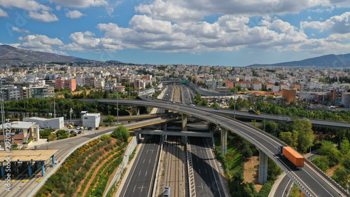 Aerial photo of multilevel junction highway overpass in urban area with beautiful sky and clouds
