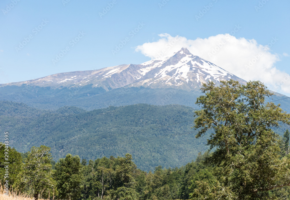 The amazing Choshuenco Volcano surrounded by clouds, over the waters of Lake Panguipulli, in southern Chile. The amazing Choshuenco Volcano surrounded by clouds, over the waters of Lake Panguipulli, in southern Chile.