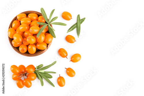 Sea buckthorn in wooden bowl. Fresh ripe berry with leaves isolated on white background with copy space for your text. Top view. Flat lay pattern