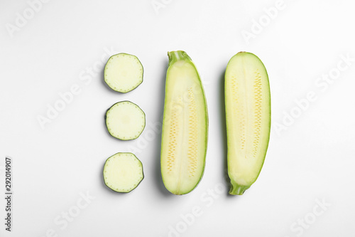 Fresh ripe cut zucchinis on white background, top view