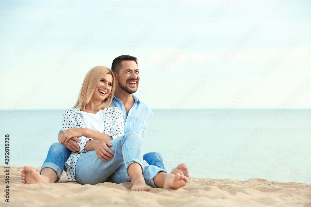 Happy romantic couple spending time together on beach, space for text Happy romantic couple spending time together on beach, space for text