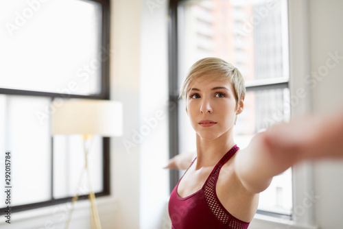 Trendy woman doing yoga as part of her mindfulness morning routine