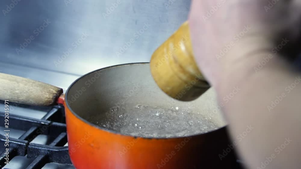 Slow motion - Adding pepper to boiling pan of water on kitchen hob, Old Fashion Kitchen. Cooking Dinner Slow motion - Adding pepper to boiling pan of water on kitchen hob, Old Fashion Kitchen. Cooking Dinner