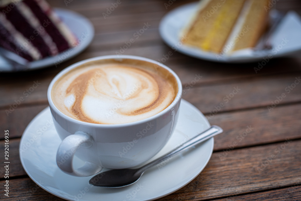 Cup of fresh aromatic cappuccino coffee and delicious dessert sweets Cup of fresh aromatic cappuccino coffee and delicious dessert sweets