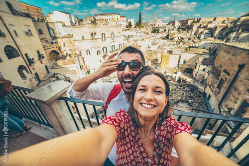 happy tourist travelling in south of italy, posing in a selfie photo in Matera, Basilicata, unesco site, capital of culture 2019 photo