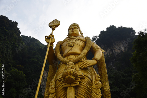 Entrance to Batu Caves with the giant, golden Murugan statue and the 272-step colorful staircase © Balazs
