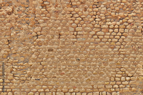 Texture stones of limestone stones brickwork. The background of vintage bricks from sandstone dating from the Roman era