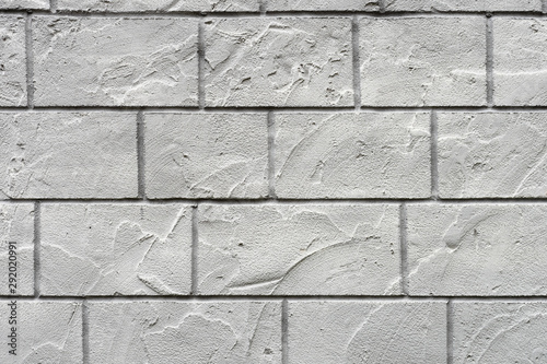 Horizontal concrete wall textured background. White grey rustic color. Grungy Shabby Uneven Painted Plaster.