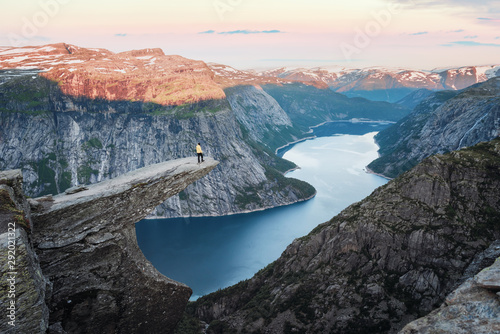 Tourist on Trolltunga rock in Norway mountains. Landscape photography photo
