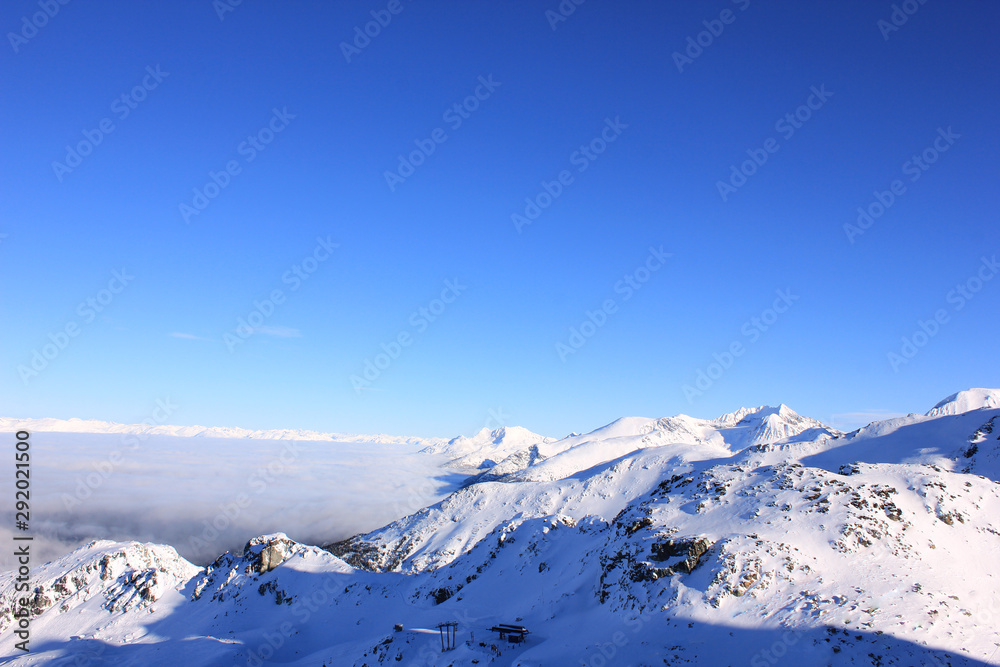 skyline with snow-covered mountains under blue sky