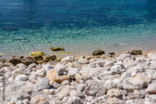 Pupnat stone beach and clear blue Adriatic sea water, Korcula, Dalmatia, Croatia, popular touristic place